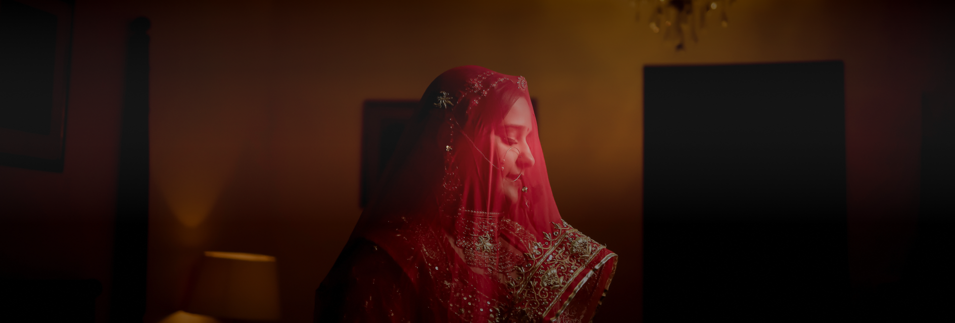 A woman wearing a flowing red veil.