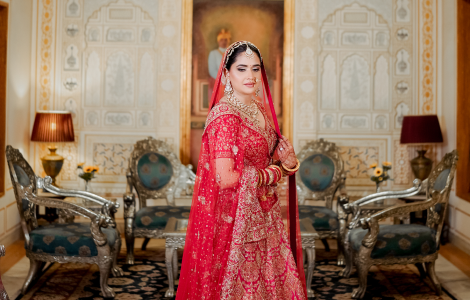 Elegant bride in a red and gold gown, showcasing beauty and grace in a bridal photography portrait.