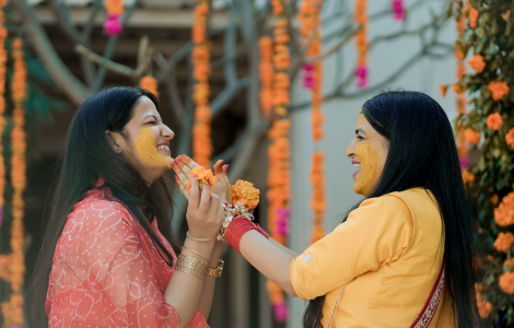 Candid photography capturing an Indian bride in a stunning orange sari.