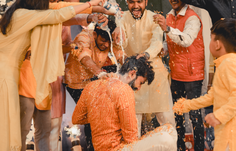 Friends and family reveling in the joyous atmosphere of a wedding, as depicted in Haldi Photography.