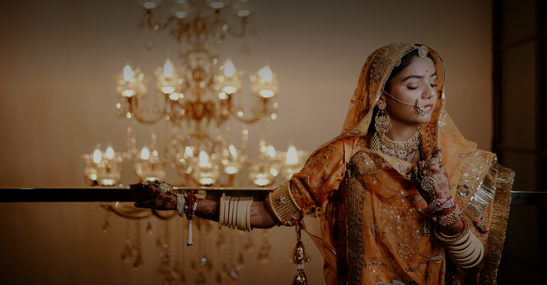 A beautiful bride in a striking orange sari.