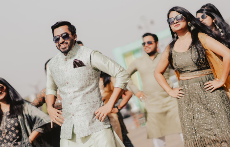 A lively group in traditional Indian attire joyfully dancing in a festive atmosphere.