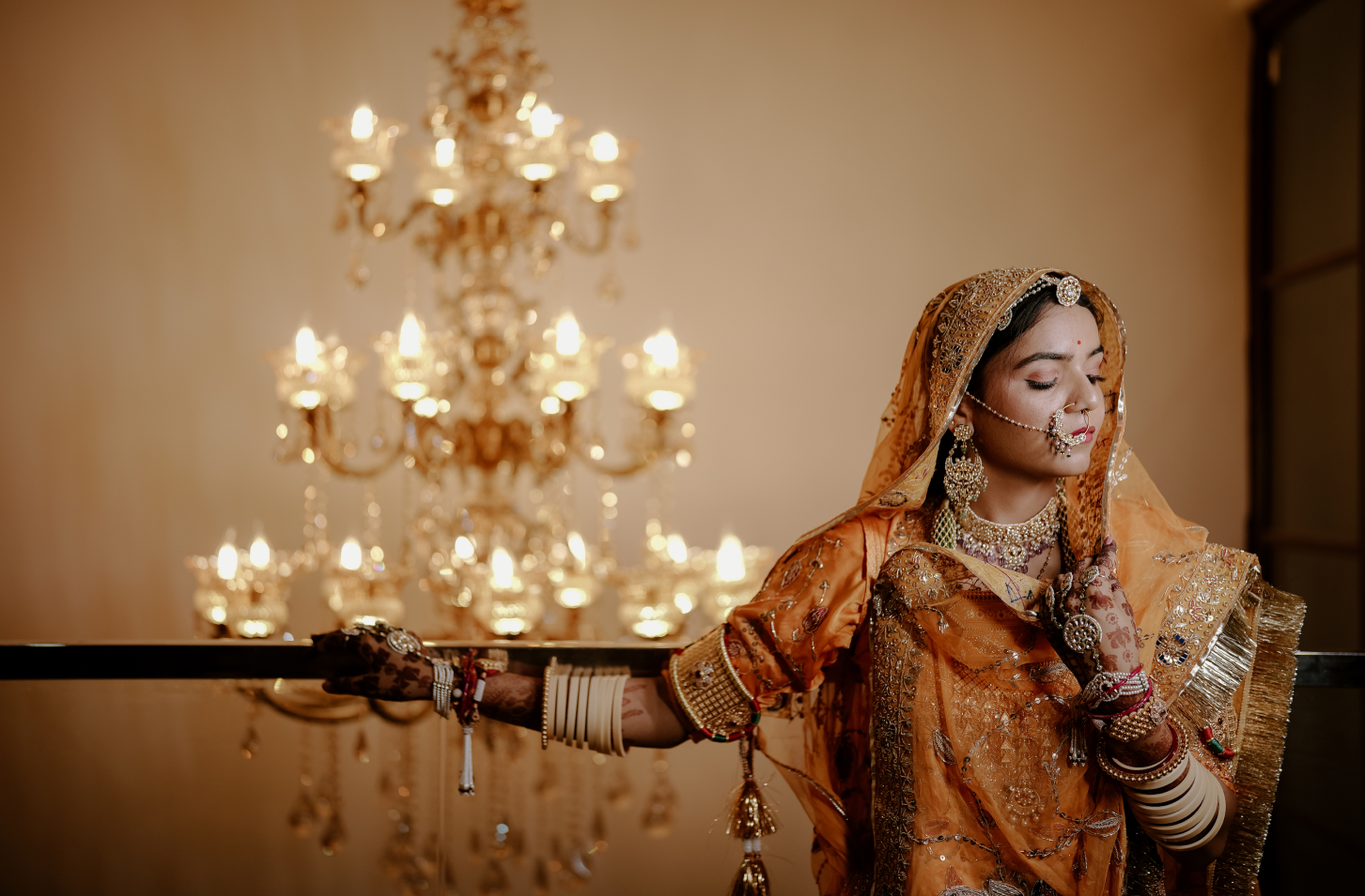 A beautiful bride in a striking orange sari.