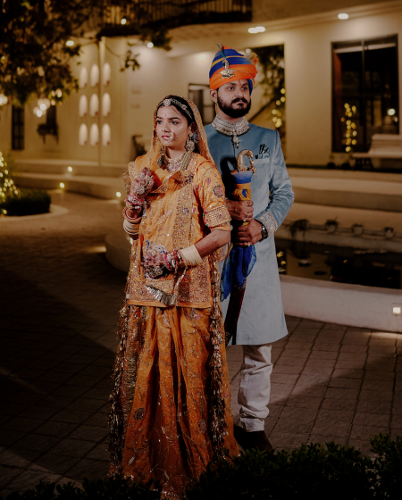 A couple joyfully celebrating their Indian wedding amidst the lively atmosphere of a city, showcasing rich cultural traditions.
