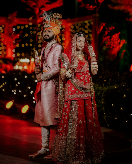 A bride and groom pose for a wedding photographer.