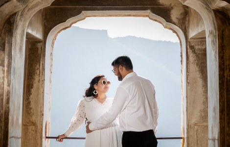 A joyful pregnant couple poses together in Jaipur - pre-wedding photography.