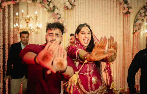 A vibrant Indian wedding reception featuring lively dance performances during the sangeet celebration.