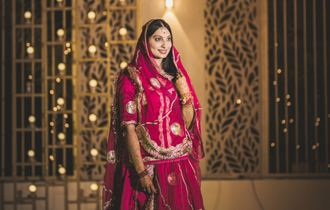  A stunning Indian women in a red lehenga, captured during a vibrant sangeet celebration.