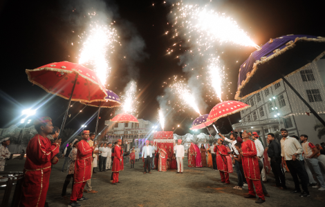 A wedding scene featuring people adorned in striking red outfits, radiating joy and celebration.