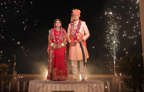 A romantic wedding photograph of a couple in Jaipur, highlighting the intricate details of their attire and the city's rich heritage.